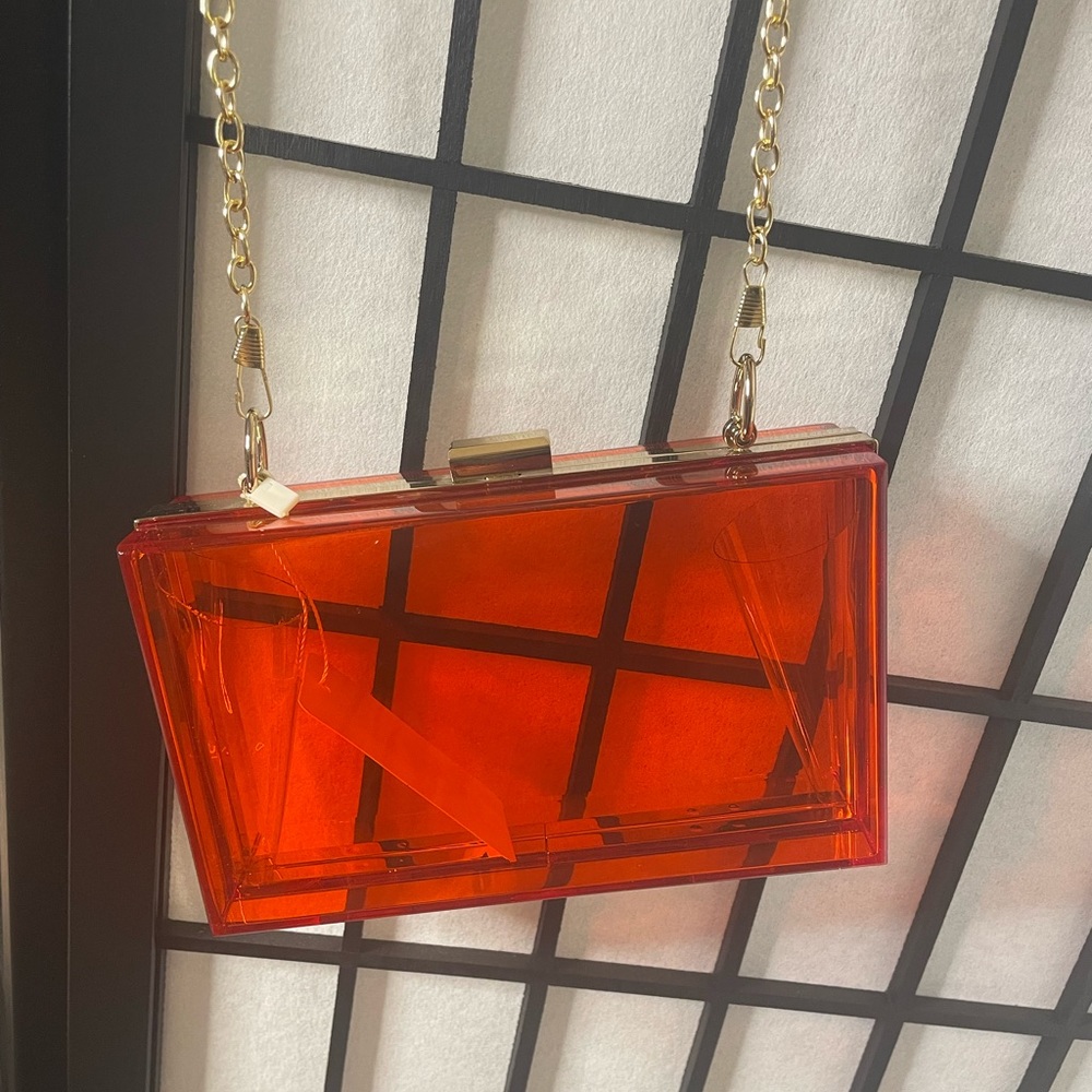 Brand new clear red clutch with gold chain